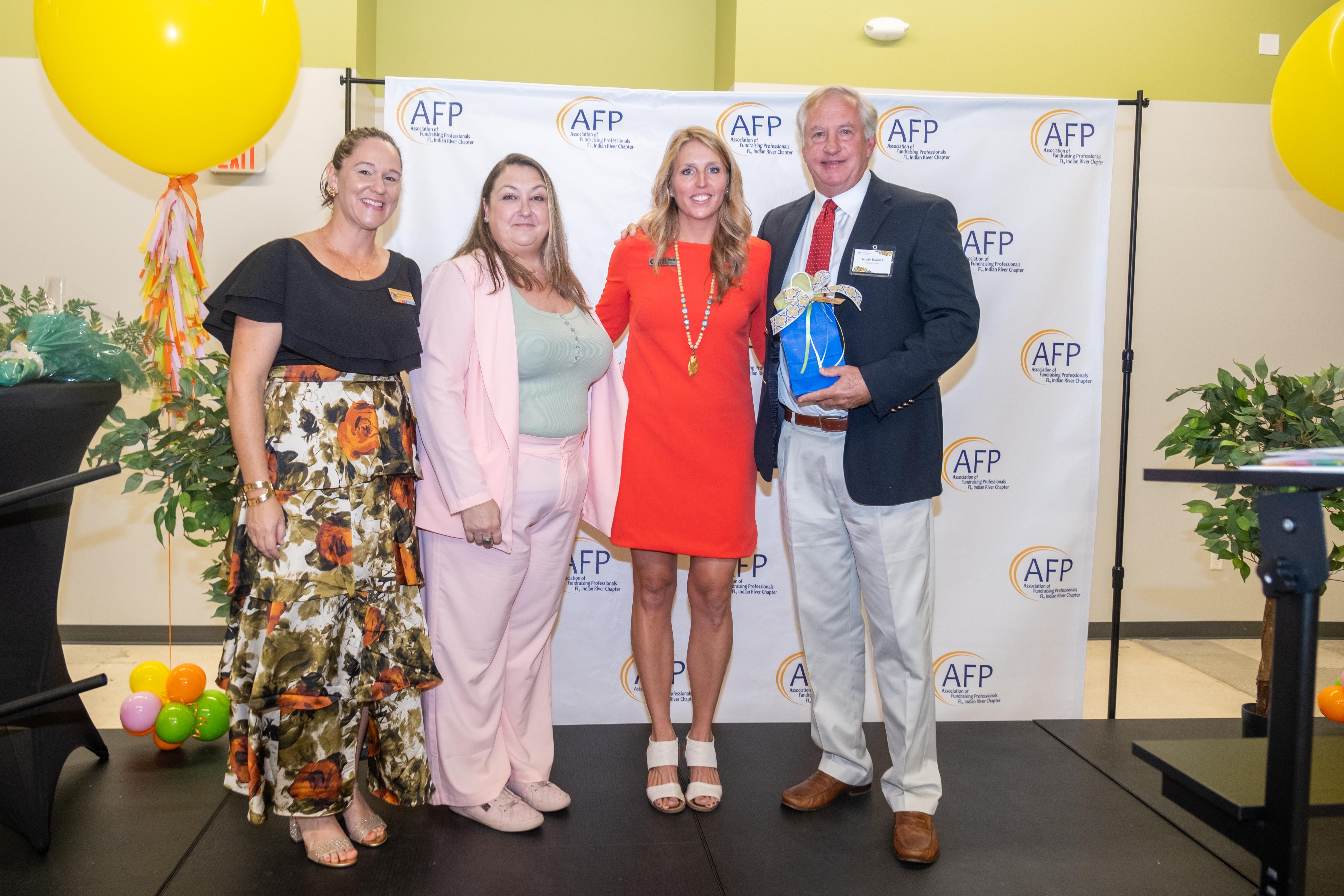 Rusty Banack accepts AFPIR's President's Award on behalf of the Banack Family